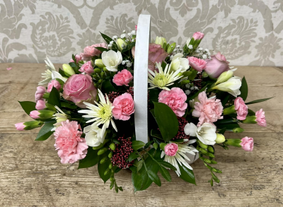 Basket Arrangement - A delightful basket arrangement filled with and beautiful fresh flowers evoking the charm of a country garden.